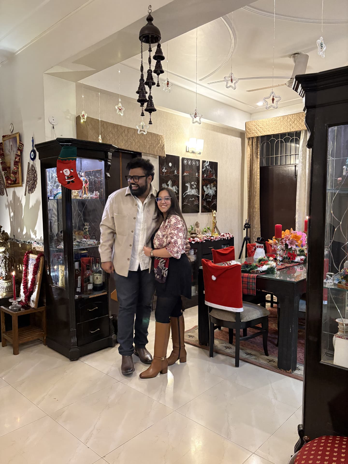 Shraddha and Arian in a festively decorated living room